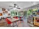Cozy sunroom with a ceiling fan, a dining table, and many windows overlooking the backyard at 2648 Oswood Dr, Tucker, GA 30084