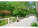 Spacious white deck overlooking a lush backyard with seating area and landscaped garden at 312 Crabapple Springs Way, Woodstock, GA 30188