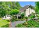 Back of house showing deck, landscaped yard, and mature greenery and trees at 312 Crabapple Springs Way, Woodstock, GA 30188