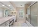 Bright bathroom features a double vanity, tiled floors, and ample counter space at 312 Crabapple Springs Way, Woodstock, GA 30188