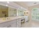 Bright bathroom features a double vanity, tiled floors, and ample counter space at 312 Crabapple Springs Way, Woodstock, GA 30188