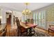 Formal dining room with plantation shutters, hardwood floors, and elegant chandelier at 312 Crabapple Springs Way, Woodstock, GA 30188