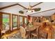 Open dining area with hardwood floors, wood trim, large windows, and seamless access to the kitchen at 312 Crabapple Springs Way, Woodstock, GA 30188