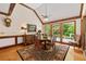 Elegant dining room with hardwood floors, wood trim, a round table, and large windows offering natural light at 312 Crabapple Springs Way, Woodstock, GA 30188