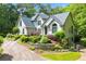 Elegant home with a lush front yard and mature landscaping, creating a welcoming curb appeal at 312 Crabapple Springs Way, Woodstock, GA 30188