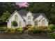 Stately two-story home with manicured landscaping, stone walkway, and elegant entrance at 312 Crabapple Springs Way, Woodstock, GA 30188