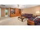Spacious living room featuring built-in shelving, plush carpeting, and comfortable seating arrangement at 312 Crabapple Springs Way, Woodstock, GA 30188