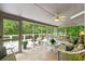 Relaxing screened porch with tiled floors, ceiling fan, and views of a lush backyard at 312 Crabapple Springs Way, Woodstock, GA 30188