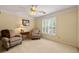 Cozy sitting room with neutral walls, plush armchairs and plantation shutters at 312 Crabapple Springs Way, Woodstock, GA 30188