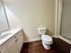 Bathroom features wood flooring, a single sink vanity, toilet, and glass enclosed shower at 4875 Carre Way, Alpharetta, GA 30022
