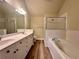 Spacious bathroom with double vanity, soaking tub, separate shower, and attractive wood-look flooring at 4875 Carre Way, Alpharetta, GA 30022