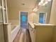 Well-lit bathroom with tub, shower, and double vanity and access to an adjoining bedroom at 4875 Carre Way, Alpharetta, GA 30022