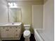 A full bathroom with a white vanity, a large mirror, a toilet, and a shower-tub combination at 4875 Carre Way, Alpharetta, GA 30022