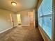A cozy bedroom with carpet flooring, a walk-in closet, and a window providing ample natural light at 4875 Carre Way, Alpharetta, GA 30022
