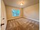 Bedroom features neutral walls, carpet flooring, a window, and a door for easy access to other areas at 4875 Carre Way, Alpharetta, GA 30022