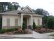 Exterior view of the clubhouse featuring stone accents, neutral siding, and manicured landscaping at 4875 Carre Way, Alpharetta, GA 30022