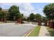 Gated entrance to the community with brick pillars and iron gates on a sunny day at 4875 Carre Way, Alpharetta, GA 30022
