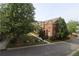 Beautiful brick townhouse complex with lush greenery and manicured lawns and mature trees at 4875 Carre Way, Alpharetta, GA 30022