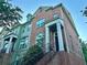 Two-story brick townhome featuring a charming entrance with wrought iron railing at 4875 Carre Way, Alpharetta, GA 30022