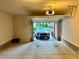 View into a garage, featuring concrete floors, a garage door, and a parked car in the driveway at 4875 Carre Way, Alpharetta, GA 30022
