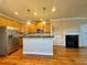 Spacious kitchen with stainless steel appliances, a center island, and a gas fireplace at 4875 Carre Way, Alpharetta, GA 30022