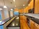 Well-appointed kitchen featuring stainless appliances, granite counters, and natural wood cabinets at 4875 Carre Way, Alpharetta, GA 30022