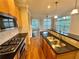 Open kitchen with granite counters, stainless appliances, and hardwood floors at 4875 Carre Way, Alpharetta, GA 30022