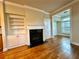 Bright living room with hardwood floors, built-in shelving, and a cozy fireplace at 4875 Carre Way, Alpharetta, GA 30022