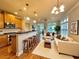 Inviting living room connected to the kitchen, complete with sofas, wood stools, and large windows at 4875 Carre Way, Alpharetta, GA 30022
