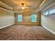 Spacious main bedroom with tray ceiling, fan, neutral carpet, and bright windows with blinds at 4875 Carre Way, Alpharetta, GA 30022
