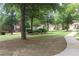 Green neighborhood view with sidewalks, greenery, trees, and well-maintained landscaping at 4875 Carre Way, Alpharetta, GA 30022