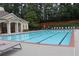 Large community swimming pool with lounge chairs and mature trees in a well-maintained area at 4875 Carre Way, Alpharetta, GA 30022