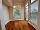 Bright room featuring hardwood floors and large windows with treetop views and an access door to the balcony at 4875 Carre Way, Alpharetta, GA 30022