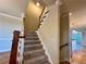Carpeted staircase with wood banister and trim, leading to the upper levels of the house at 4875 Carre Way, Alpharetta, GA 30022