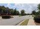 Street corner surrounded by townhomes and green landscape, under a partly cloudy sky at 4875 Carre Way, Alpharetta, GA 30022