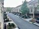 Townhouse complex street view shows car parking and neat landscaping and a well-maintained neighborhood at 4875 Carre Way, Alpharetta, GA 30022