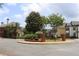 A roundabout in Abberley Township with manicured landscaping and well-maintained townhomes at 4875 Carre Way, Alpharetta, GA 30022