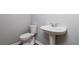Bathroom features a toilet and single pedestal sink at 112 Hawkeye Ln, Conyers, GA 30012