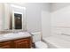 Bathroom features a wood cabinet with sink, mirror, tub, and toilet at 112 Hawkeye Ln, Conyers, GA 30012