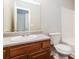 Bathroom features a wood cabinet with sink and toilet at 112 Hawkeye Ln, Conyers, GA 30012