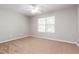 Bright bedroom with plush carpeting and large window offering plenty of natural light and space at 112 Hawkeye Ln, Conyers, GA 30012