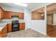 Functional kitchen with wooden cabinetry, black appliances, and an open layout for easy access at 112 Hawkeye Ln, Conyers, GA 30012