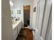 Bright bathroom with a wood floor, white vanity, and framed mirror, providing ample space at 2671 Club Forest Se Ct, Conyers, GA 30013