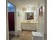 Traditional bathroom with white vanity, large mirror, and access to the separate toilet area at 2671 Club Forest Se Ct, Conyers, GA 30013