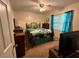 Cozy bedroom with a wrought iron bed frame and blue accents, showcasing a simple and functional design at 2671 Club Forest Se Ct, Conyers, GA 30013