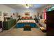 Bedroom featuring an upholstered bed, natural light, and colorful artwork at 2671 Club Forest Se Ct, Conyers, GA 30013