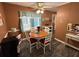 Cozy dining area with wood flooring and a charming window with blue patterned curtains at 2671 Club Forest Se Ct, Conyers, GA 30013