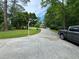 Spacious driveway leading to a well-maintained home amidst lush greenery at 2671 Club Forest Se Ct, Conyers, GA 30013