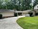 Charming home with manicured lawn, featuring a basketball hoop and attached garage at 2671 Club Forest Se Ct, Conyers, GA 30013