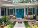 Inviting front porch with seating, blue shutters, double door and manicured landscaping at 2671 Club Forest Se Ct, Conyers, GA 30013